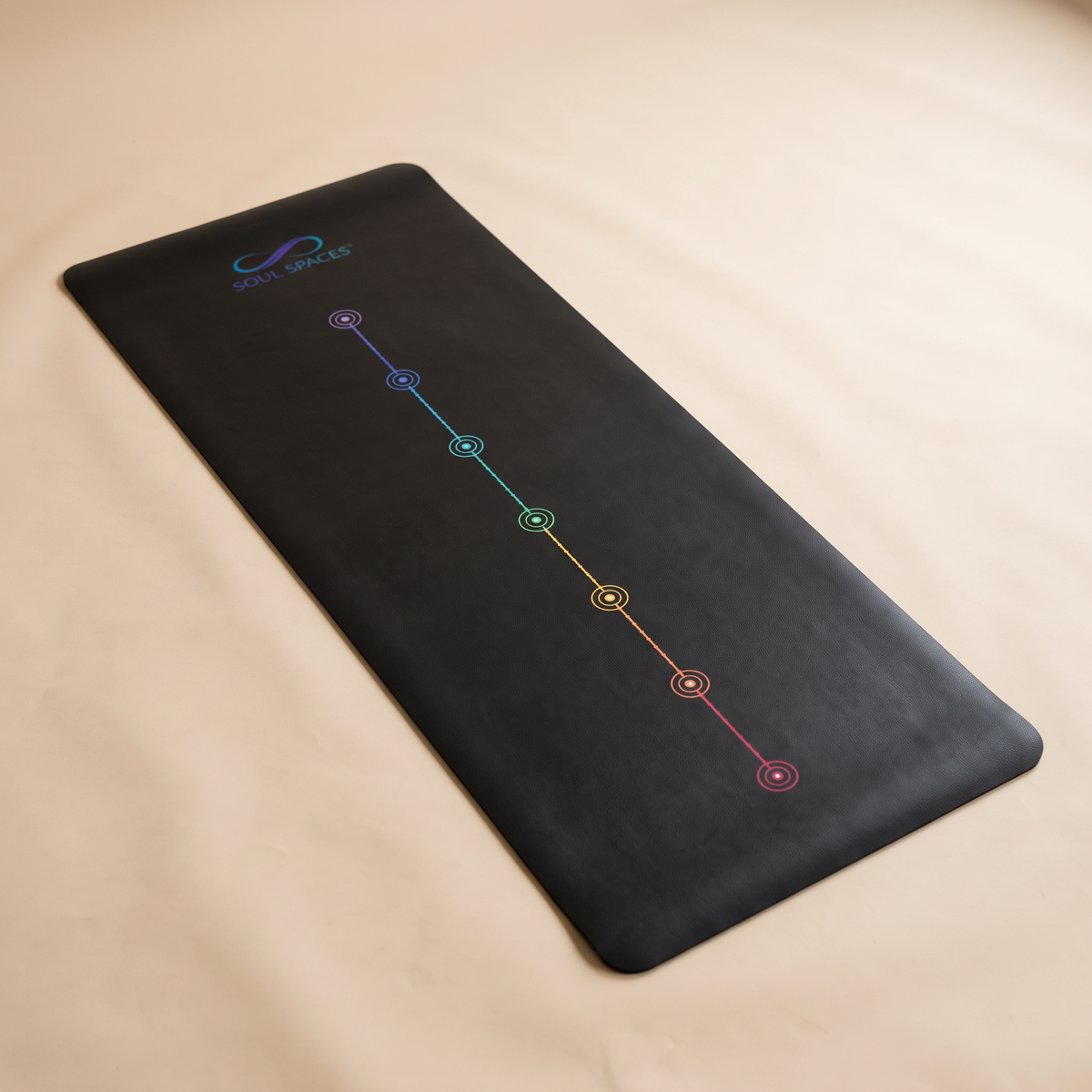 Soul Spaces Yoga Mat unrolled on a cream background, logo and alignment line visible