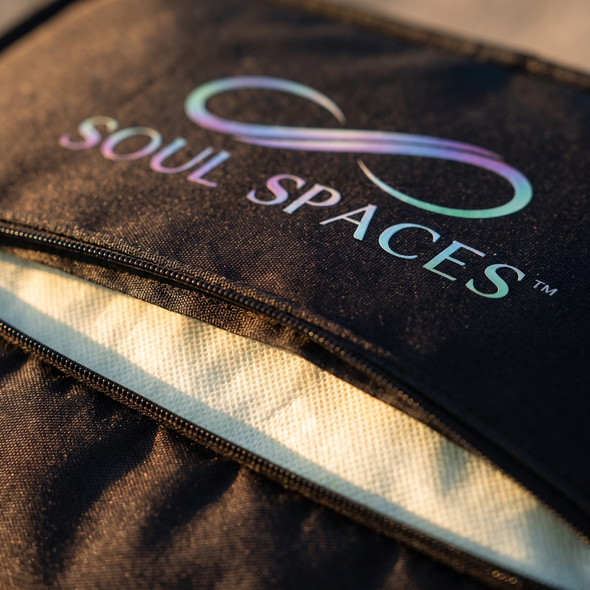 The Sanctuary Sauna Blanket zipper and Soul Spaces logo with the Ritual Insert visible inside