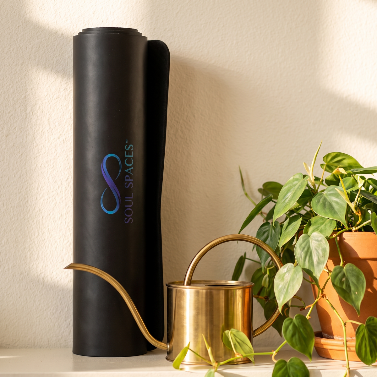 Soul Spaces Yoga Mat rolled and standing upright, logo reading vertically